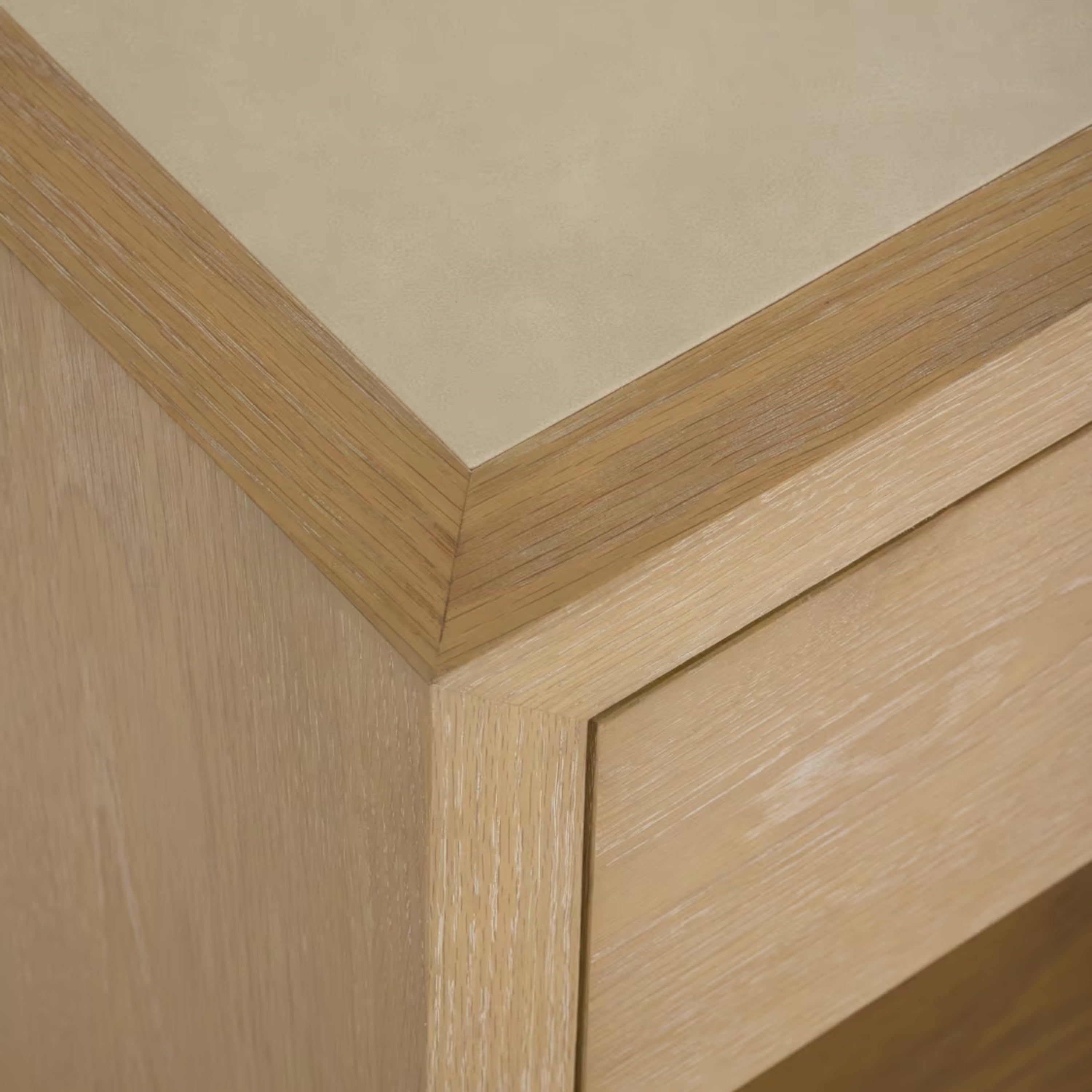 Cleo Nightstand close-up showing inset cream top and pale wood frame