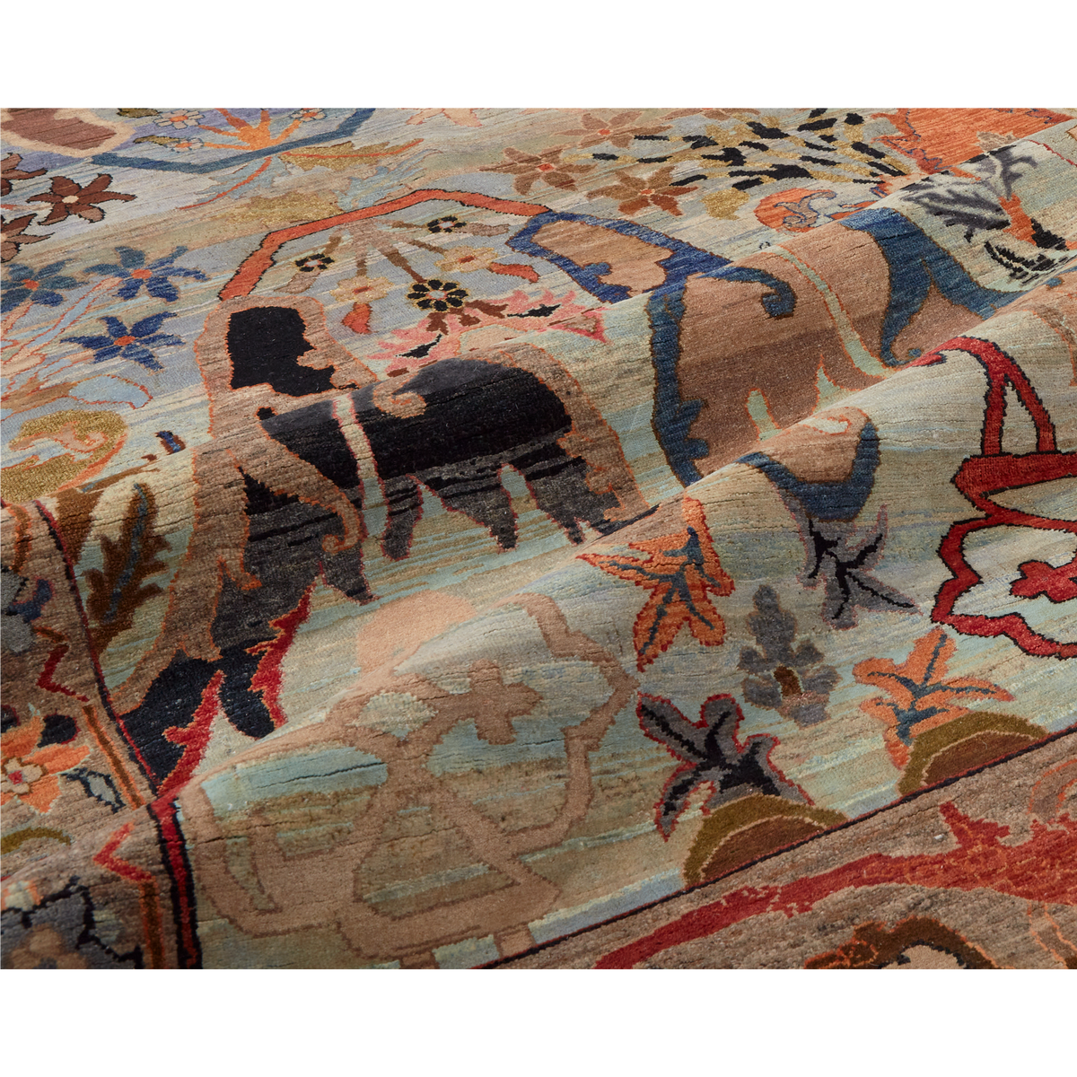 A close-up of a patterned area rug with a hand-drawn style design featuring a horse, floral motifs, and abstract shapes in beige, brown, blue, red, black, and orange.