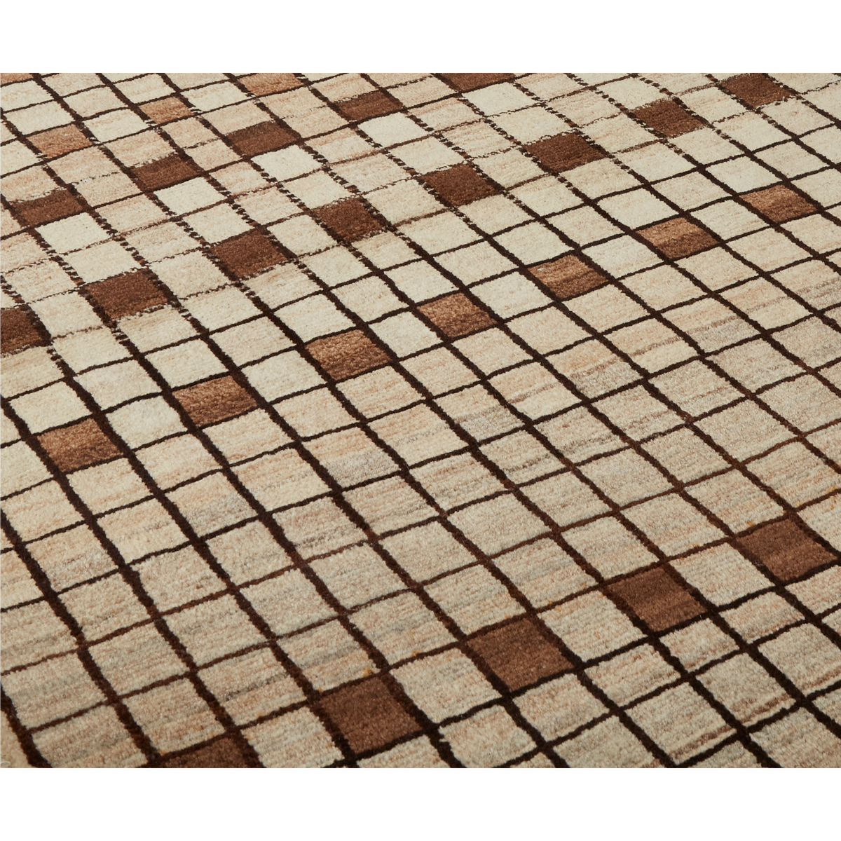 A close-up of a woven rug with a geometric checkered pattern in beige, cream, and brown.