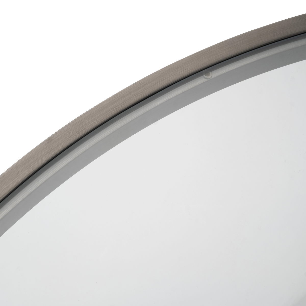Close-up showing the Tenor Round Coffee Table’s glass edge seated inside the Aged Pewter brushed metal ring, with a fine brushed grain and a small round pad at the rim.