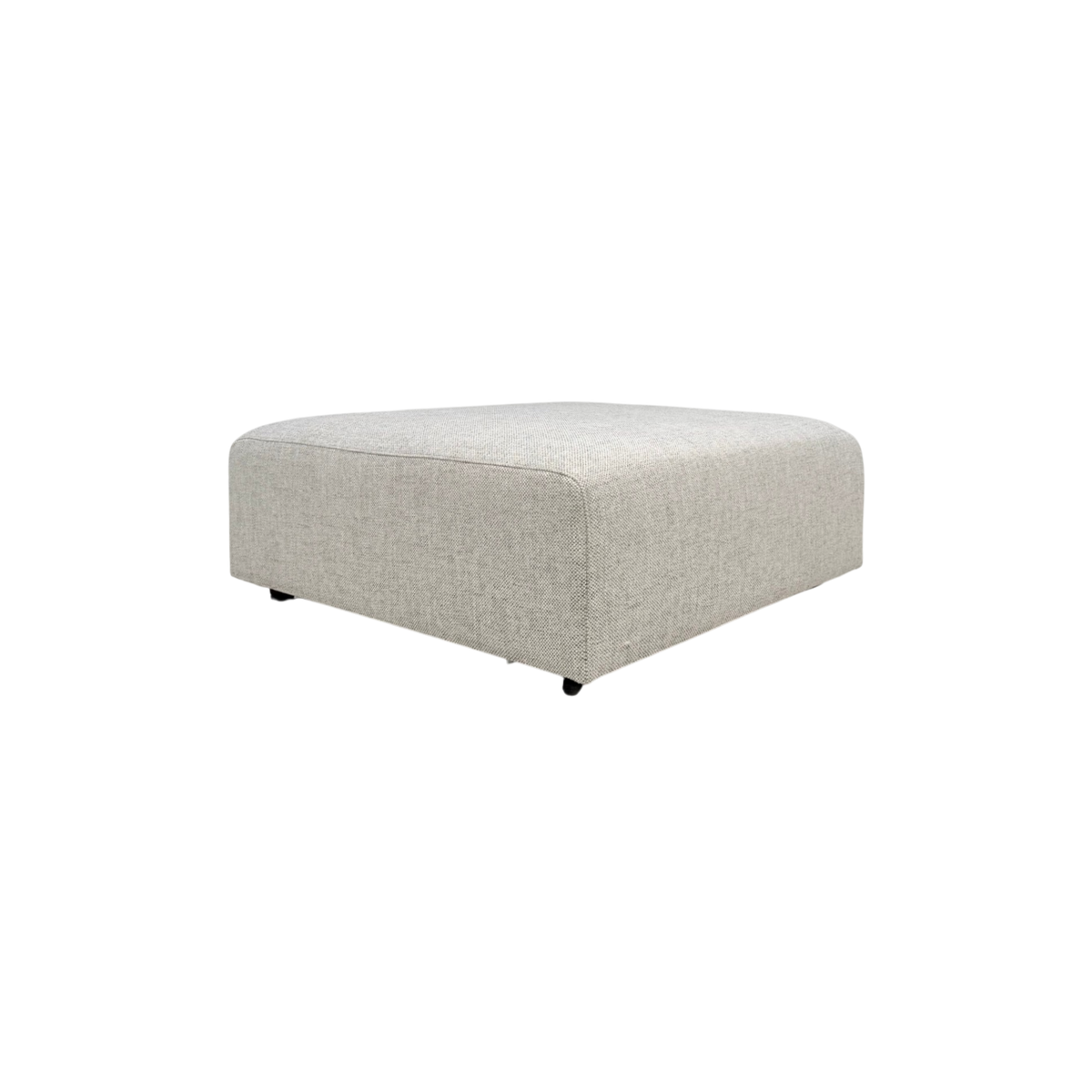 Vetro Bullnose Ottoman in light woven grey upholstery, three-quarter view showing the low, wide form and softly rounded edges.