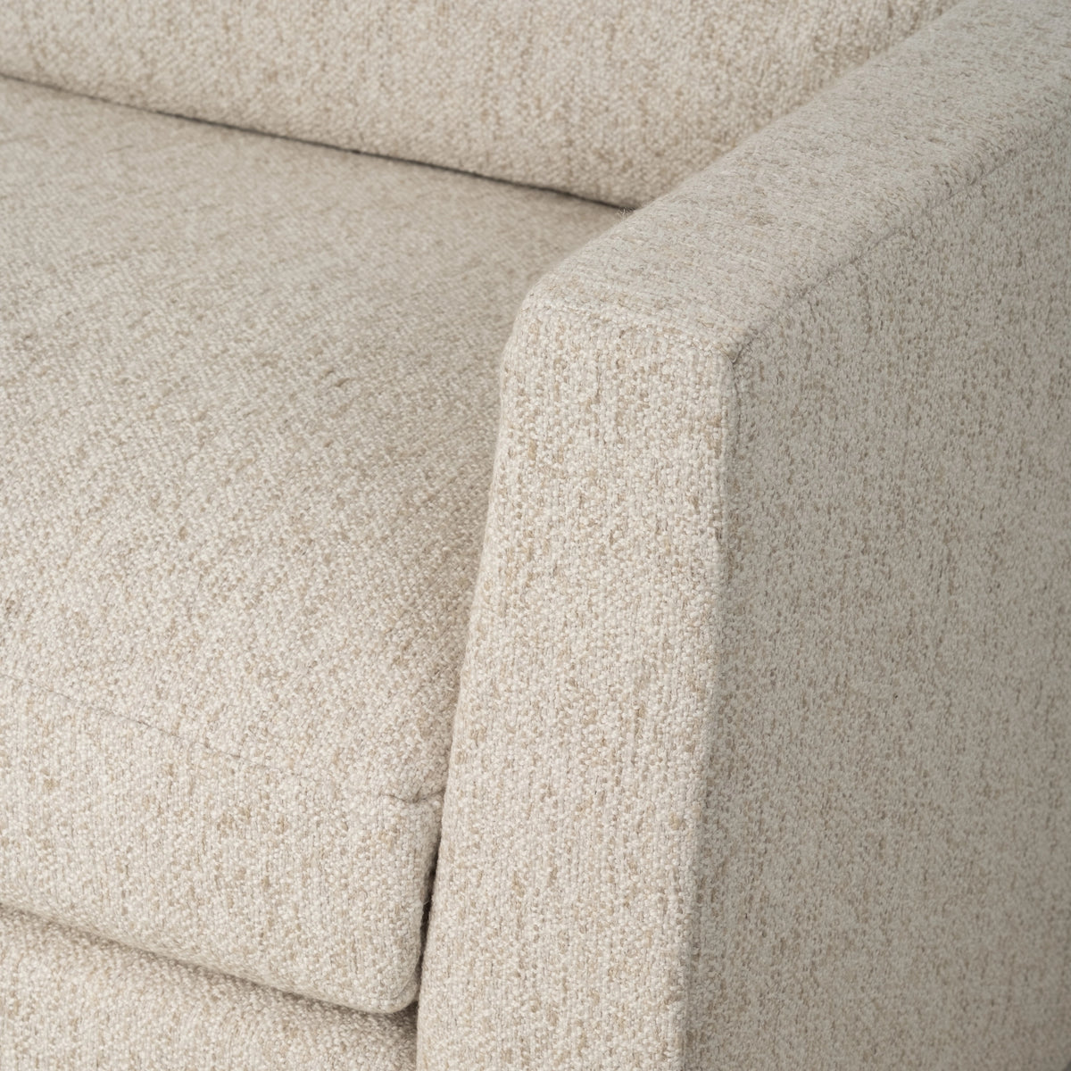 Kore Taper Arm Sofa in Oatmeal textured fabric shown in close-up along the tapered arm and seat cushion, with a crisp edge and a tight, heathered texture.