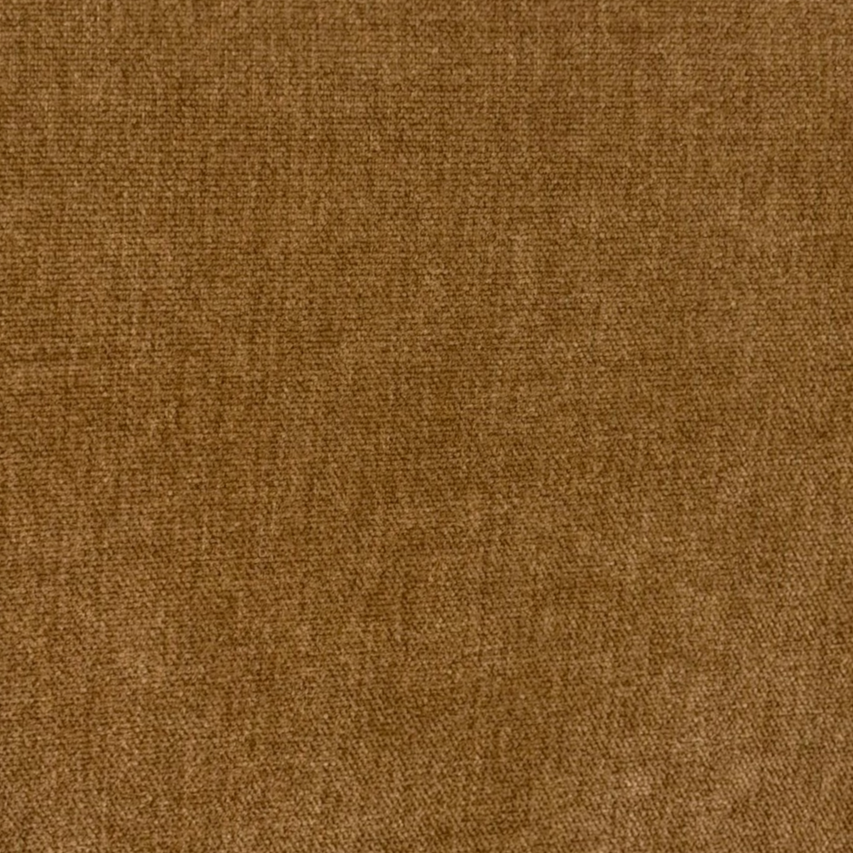 Close-up showing Caramel velvet upholstery with a fine, low pile and subtle tonal mottling.