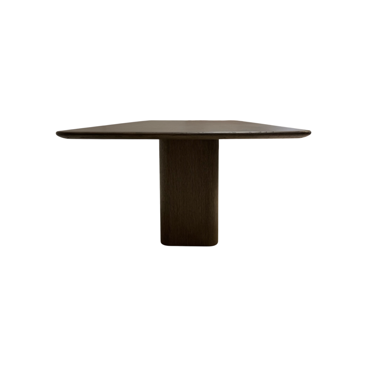 Angled view of the Altar 96-inch Dining Table showing its elongated wood top, gently softened corners and architectural pedestal base.