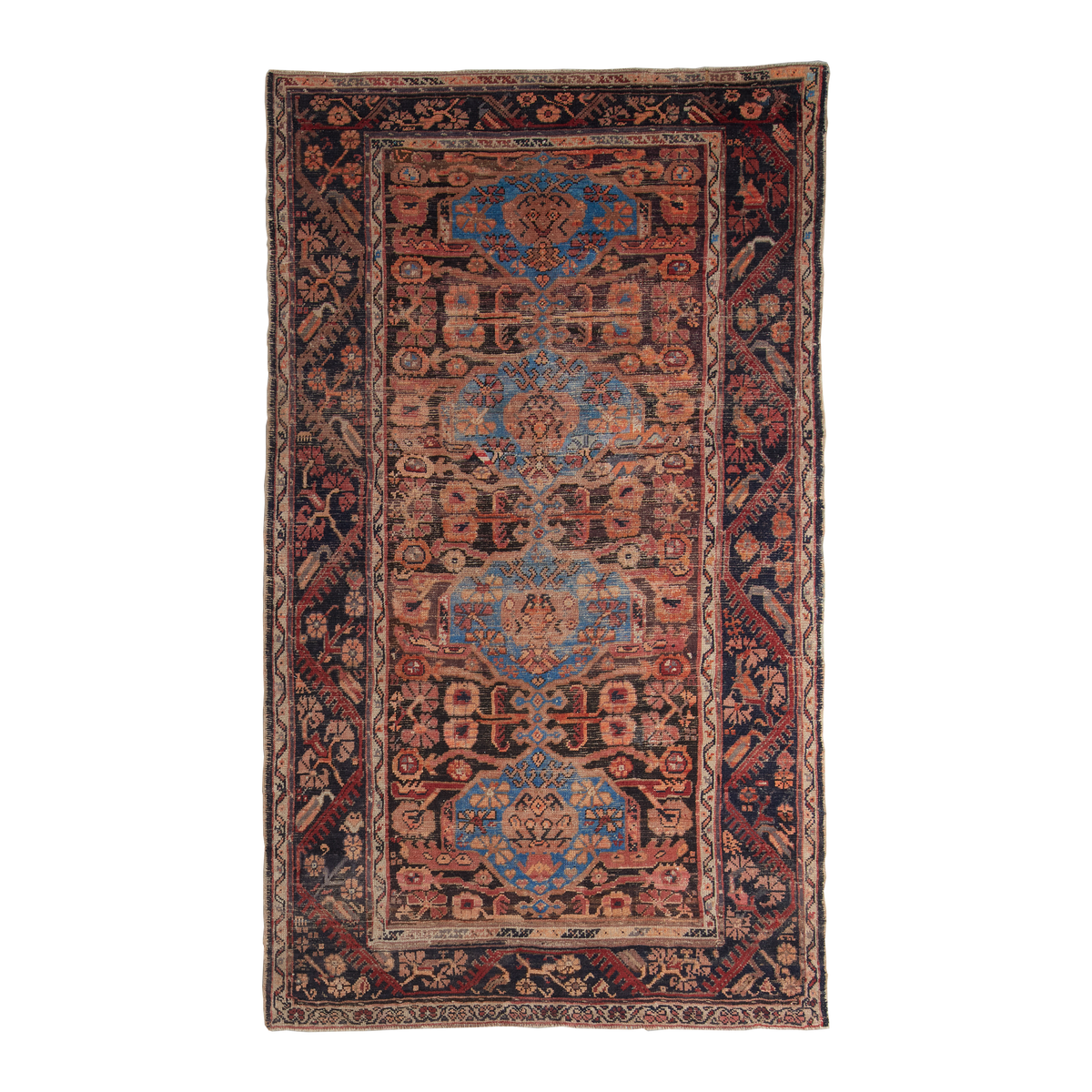 A rectangular vintage-style area rug with an intricate traditional pattern, featuring a central field of rust red, blue, and beige motifs surrounded by dark navy and red borders, shown flat against a white background.