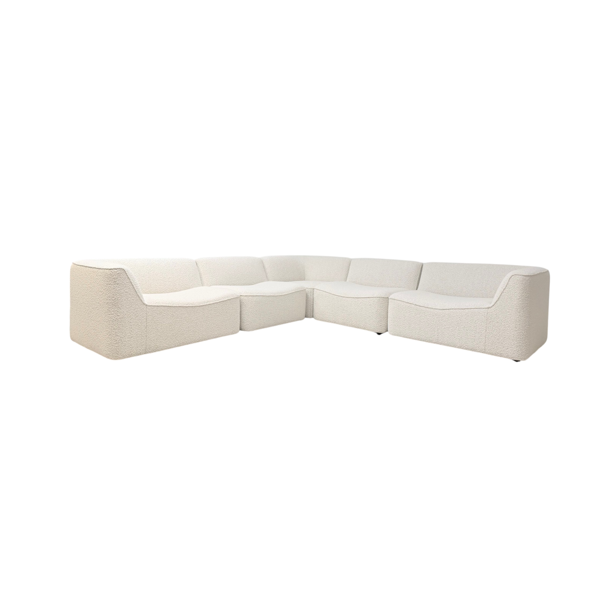 Bento Modular Sectional in ivory bouclé, angled front view showing a sculptural U-shaped configuration with softly curved seats, rounded corners, and a continuous low back.