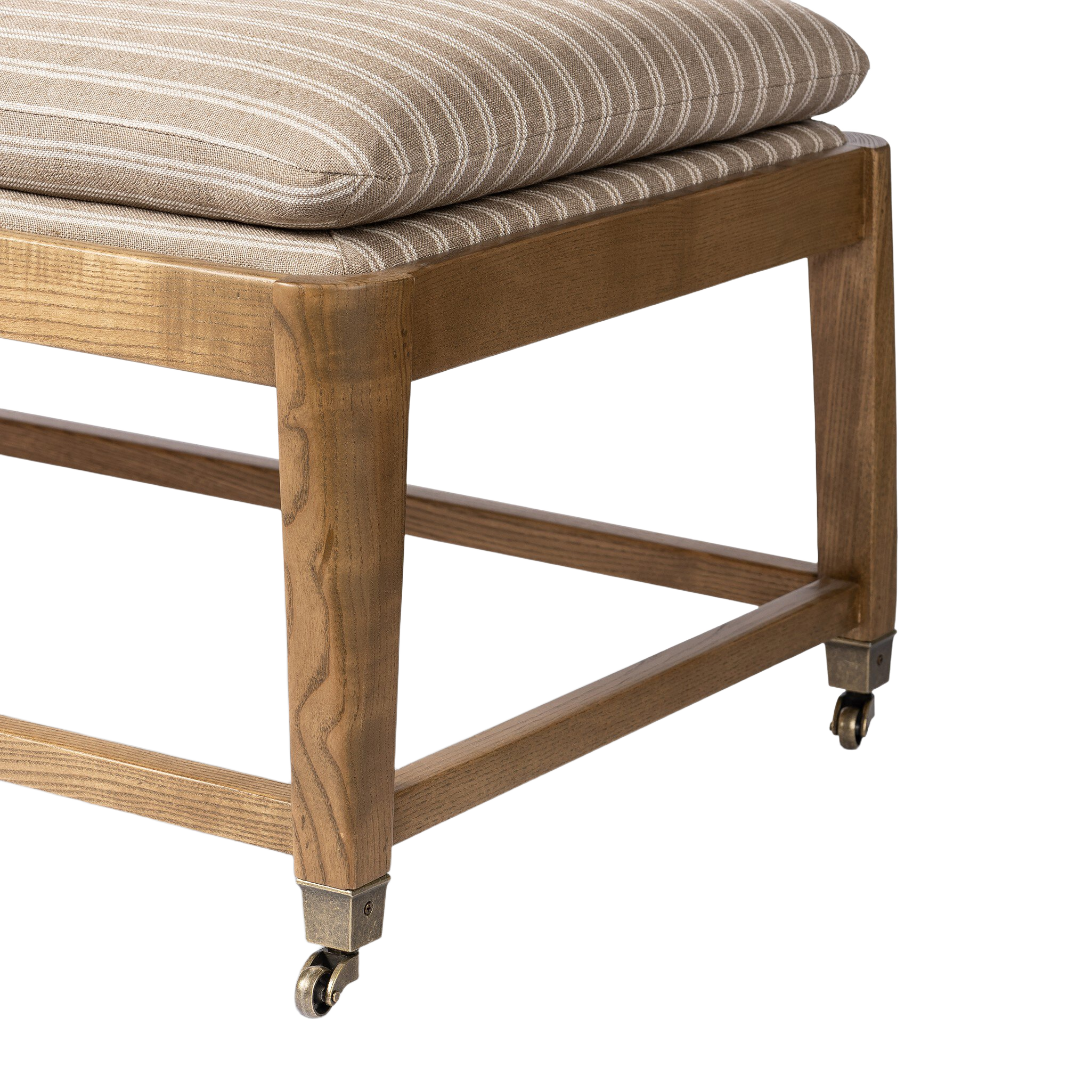 Close-up of the Serafina Bench showing the taupe-and-ivory striped upholstery, warm wood grain, open stretcher frame and antique-style metal casters.