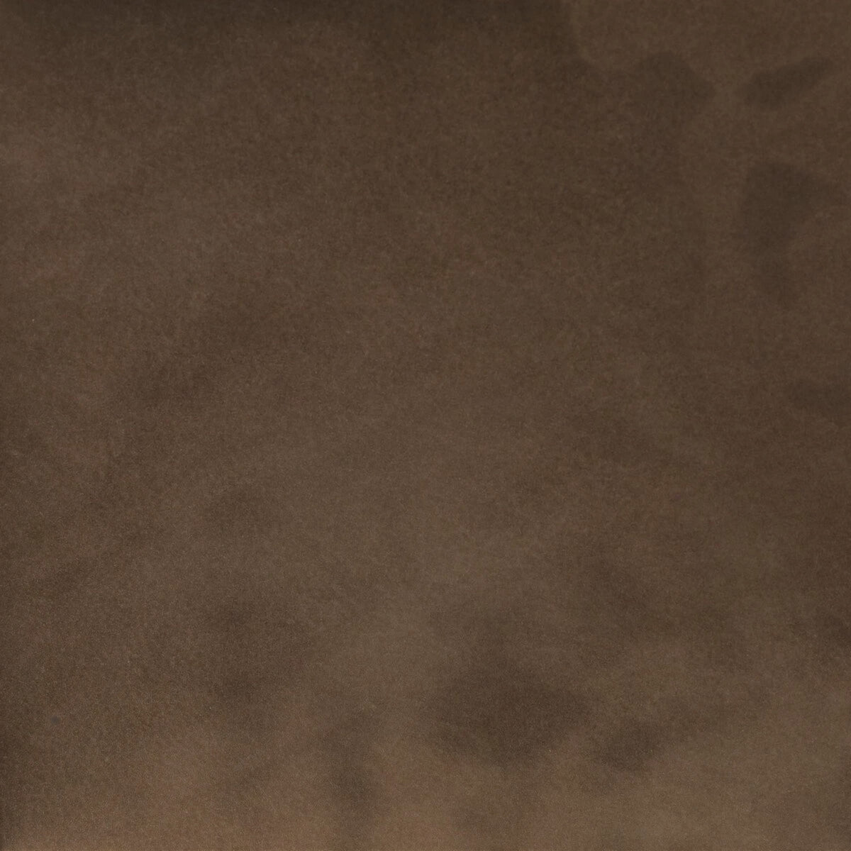 A close-up of a textured brown material, resembling suede for Bauer Ottoman.
