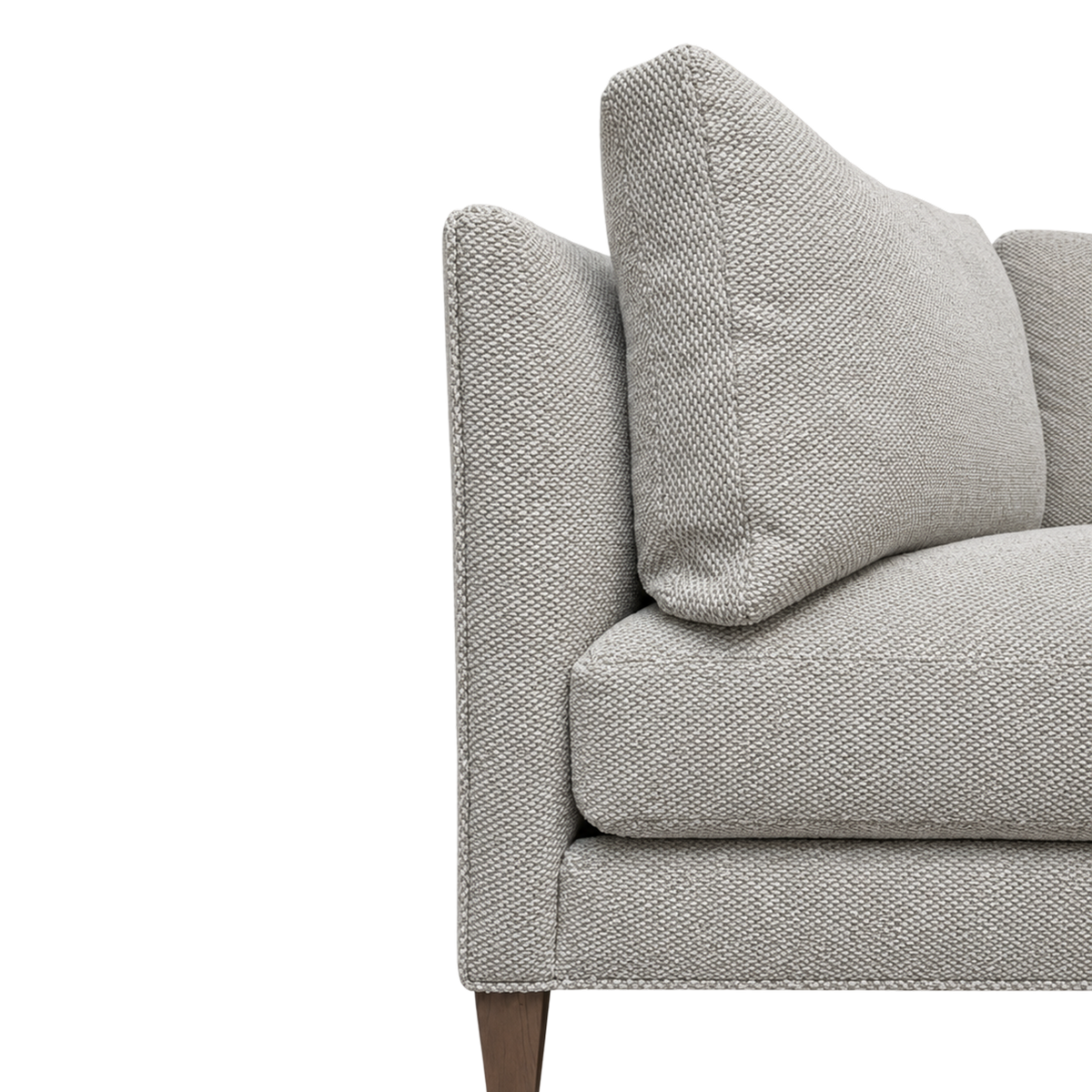Parker Sofa close-up showing the oatmeal bouclé texture at the arm-to-back seam, with its nubby, heathered weave and tapered wood leg.