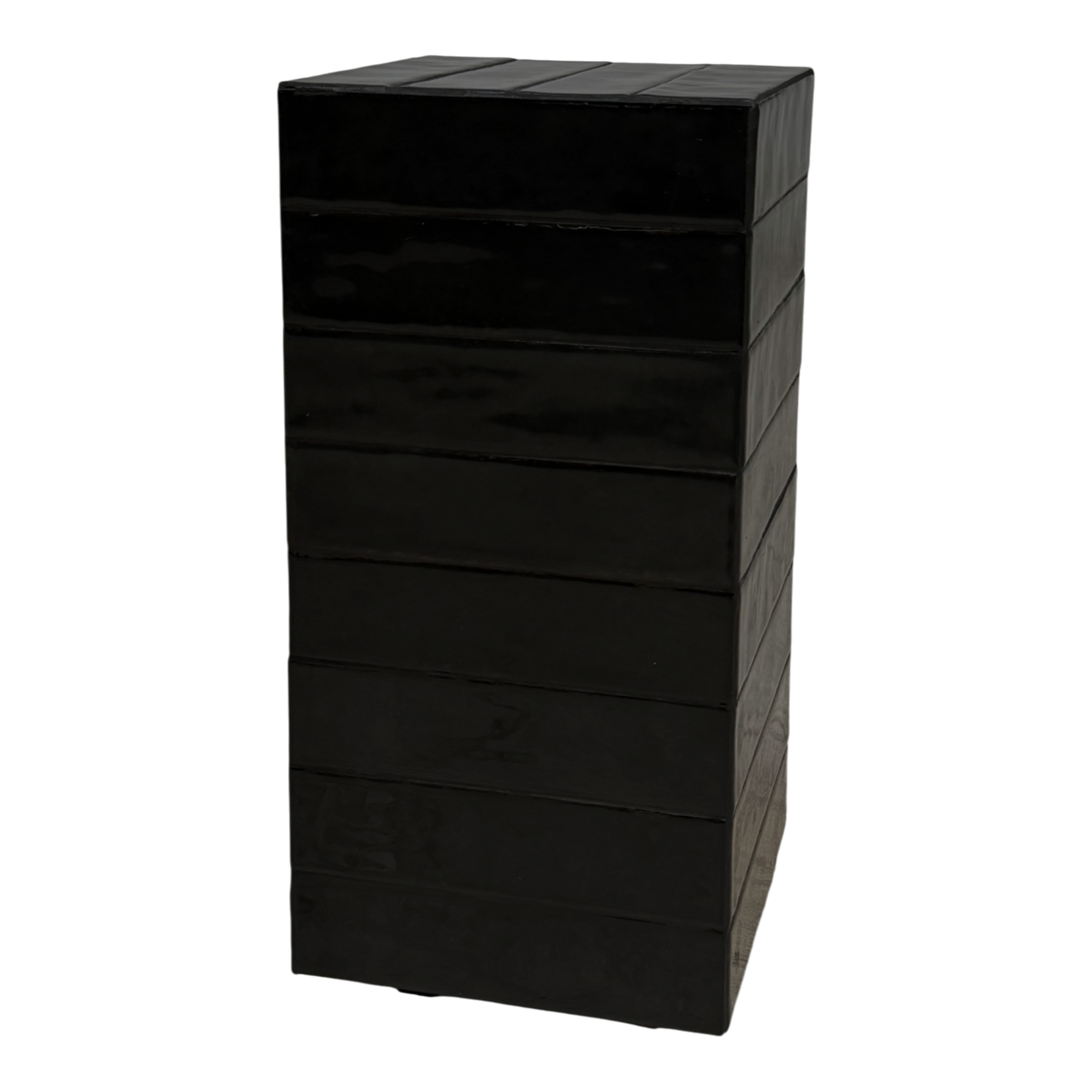 Bloor Side Table in deep black, shown at an angle to highlight its monolithic form, horizontal banding and hand-worked surface.