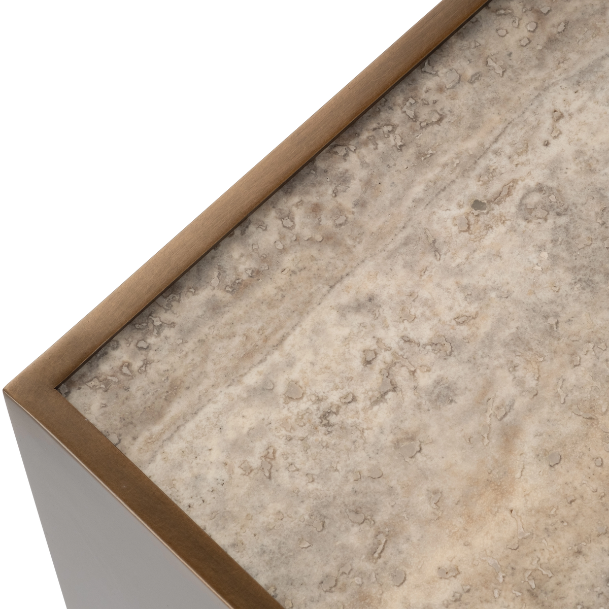 Close-up showing the Pedra Square Side Table’s thin Aged Bronze metal rim framing the taupe travertine top, with natural pitting and soft veining.