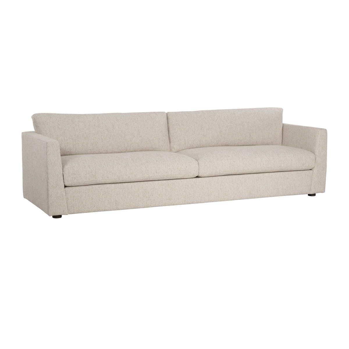 Angled view highlighting the long, low profile, the plush seat cushions, and the tapered arms of the Kore Taper Arm Sofa in Oatmeal textured fabric.