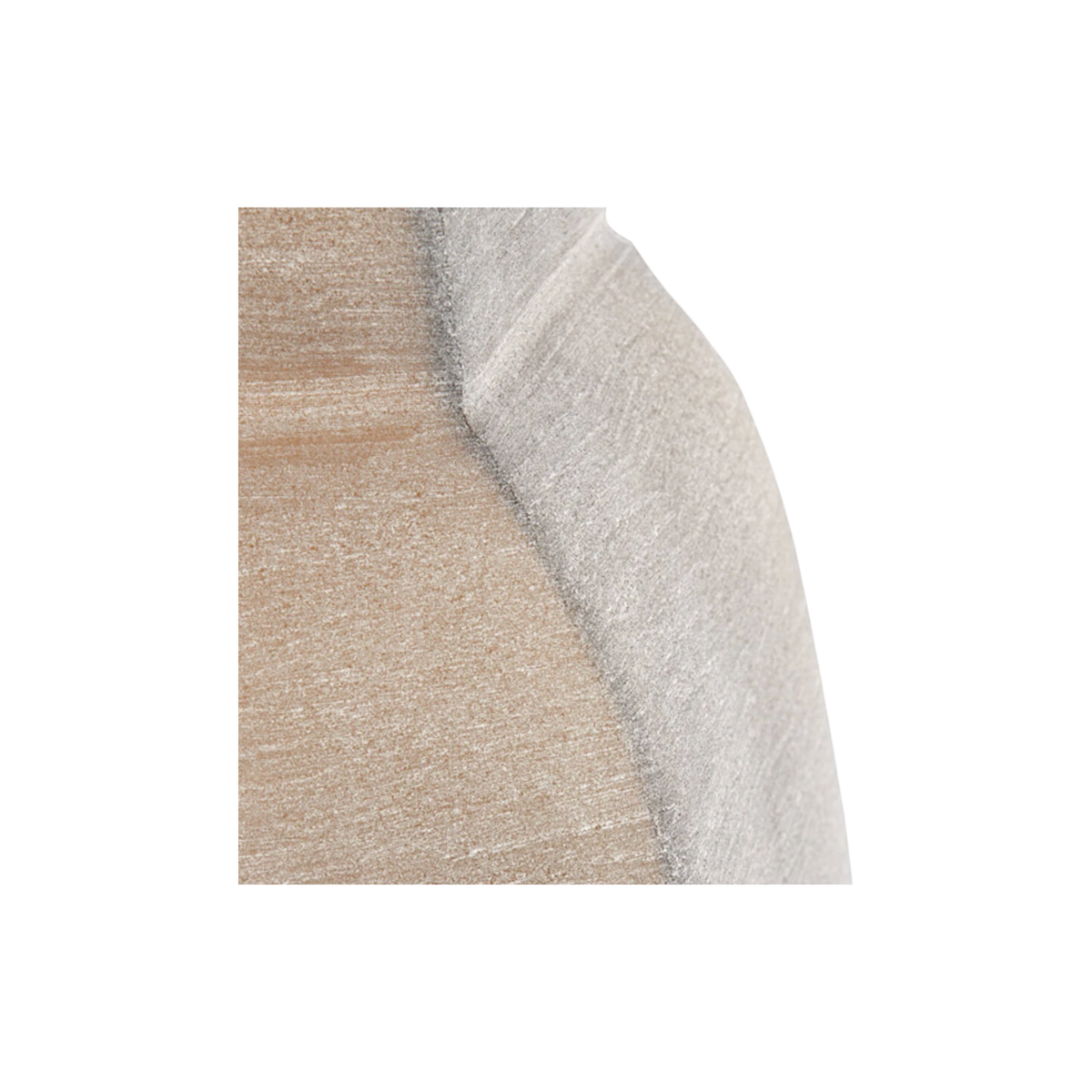 Close-up showing the seam between the sandy-brown panel and the pale taupe facet of the glass vase, with a darker edge line and horizontal brushed texture.
