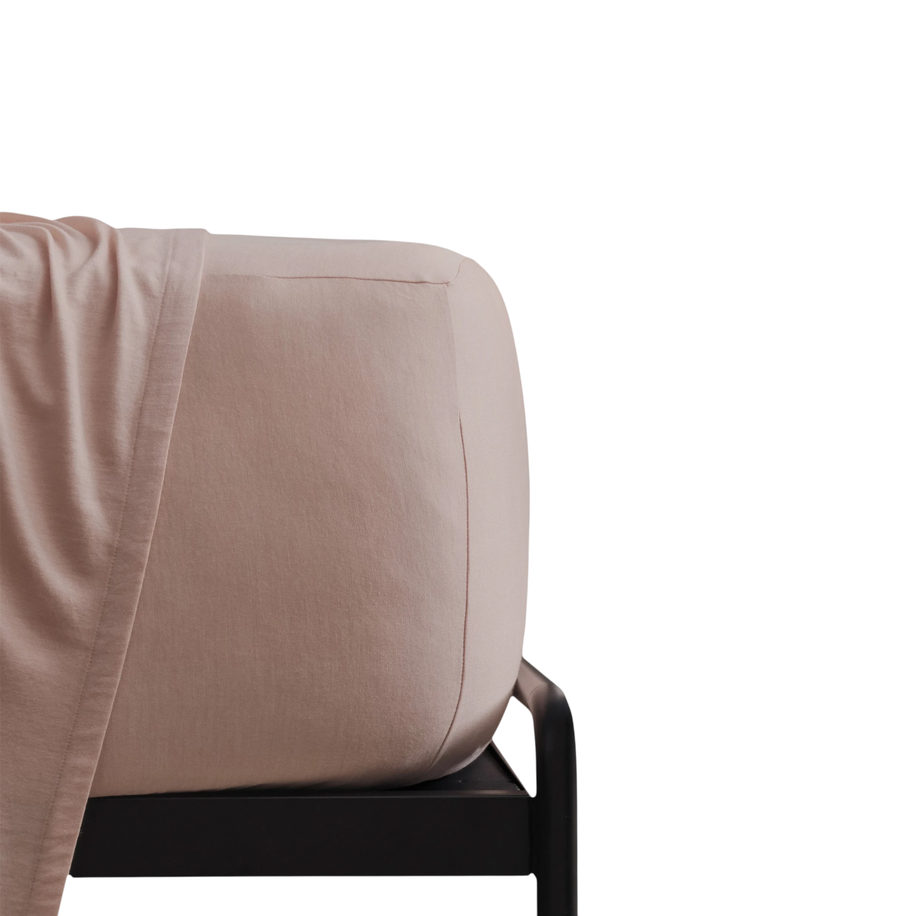 Merino Fit Sheet Queen in Rose Merino Jersey is shown fitted over a mattress with coordinating bedding draped over the edge.