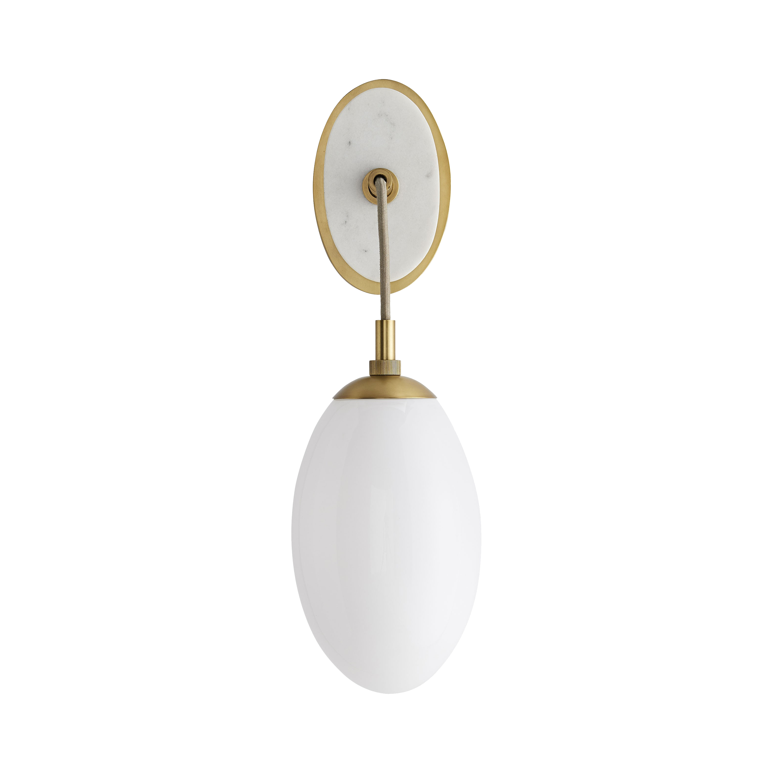 An oval, solid white marble stone, backed with steel finished in antique brass, showcases a large teardrop-shaped opal glass shade that is suspended by a taupe cloth cord, establis