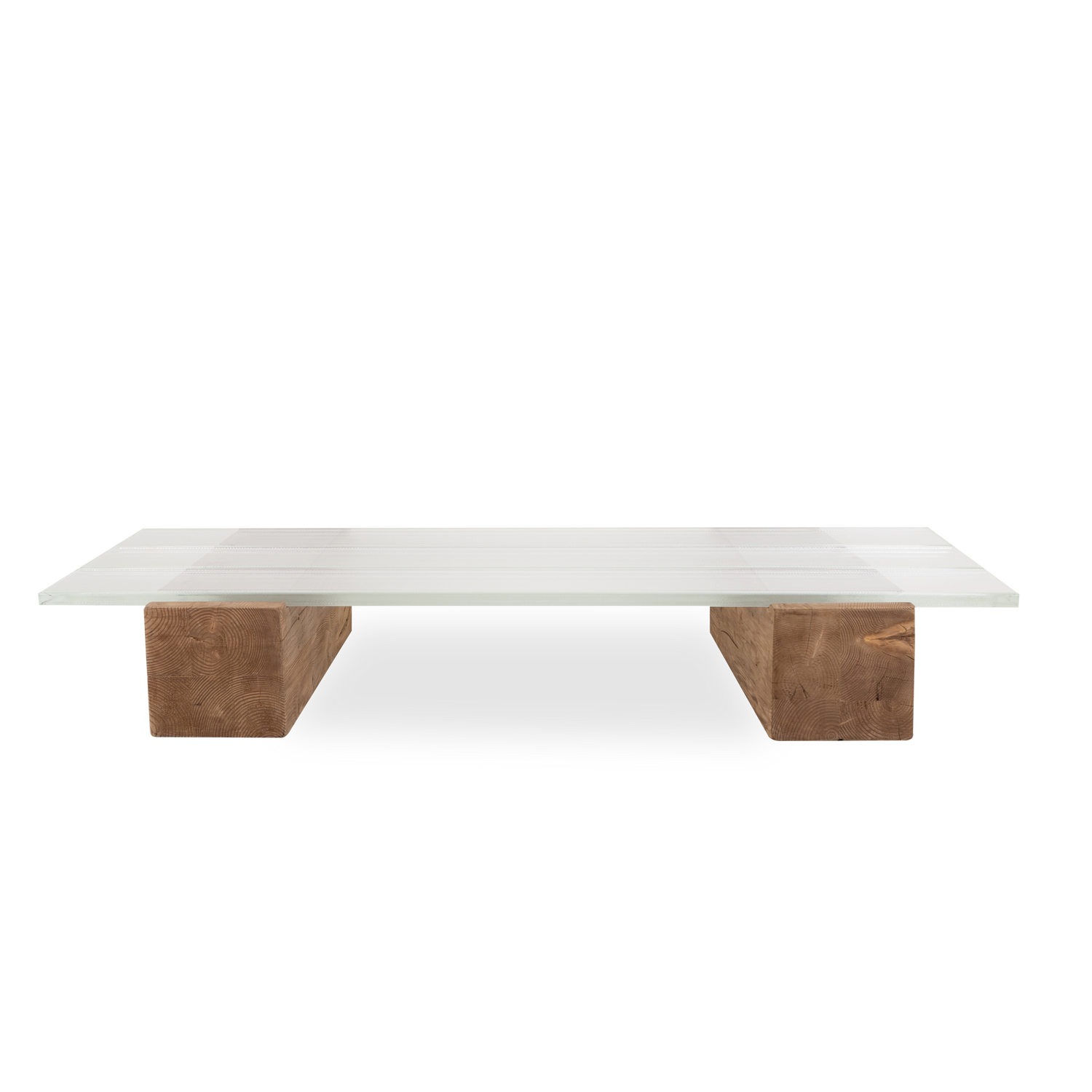 Proving the adage that there is beauty in simplicity%2C the epic Icebeam coffee table grounds a space with its mighty reclaimed timber blocks topped with three ice-like beams of glas